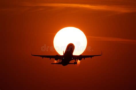 Airplane Landing or Takeoff in the Sunset with Red Sky in Bucharest ...