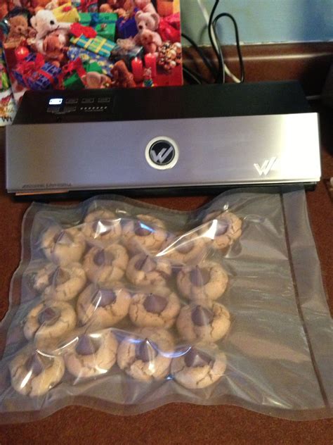 A Bag Of Cookies Sitting On Top Of A Table Next To A Laptop Computer