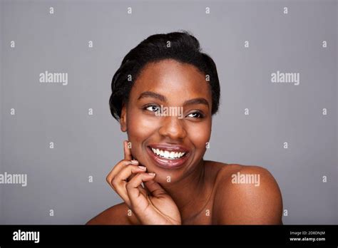 Close Up Portrait Of Smiling Black Woman With Hand To Face And Bare