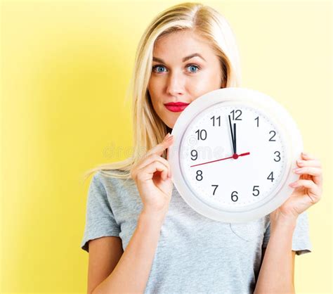 Woman Holding Clock Showing Nearly Stock Image Image Of Countdown