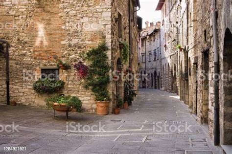 An Alley Of A Medieval Italian Village With Stone Houses Wooden Doors