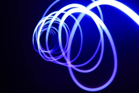 Premium Photo Blue Spirals Of Light And Dark Background