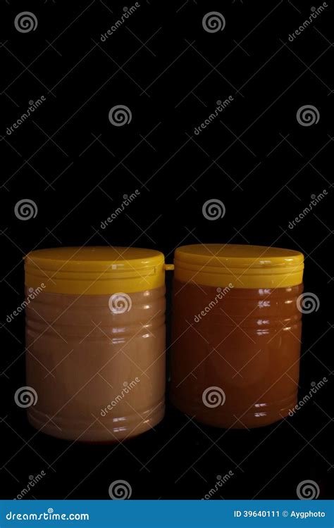 Two Natural Honey Yellow Jars With Plain Black Bac Stock Image Image