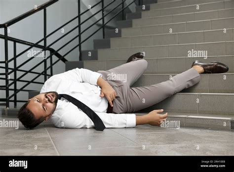 Man Fallen Down Stairs Suffering From Pain Indoors Space For Text