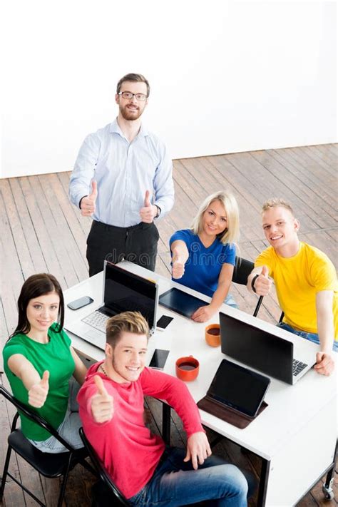 Students With Teacher Studying Using Modern Technologies With Thumbs Up