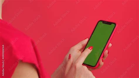 Woman Holds Mobile Phone With Green Workspace Mock Up Screen On Red