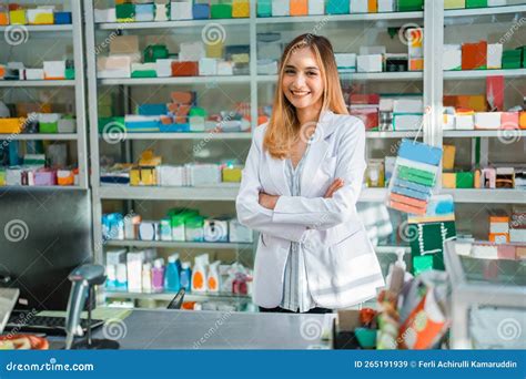 Attractive Pharmacist in Uniform Smiling at Camera with Crossed Hands ...