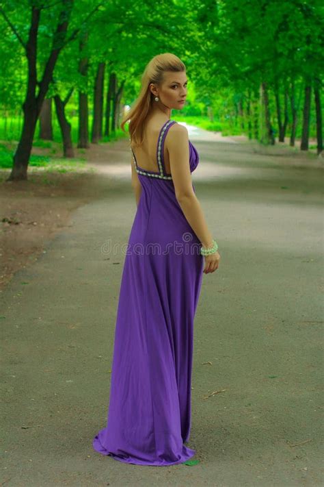 Blonde Beautiful Natural Girl With Blonde Hair In A Lilac Dress In