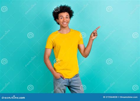 Photo Of Satisfied Pleasant Guy Dressed Yellow T Shirt Directing At Banner Empty Space Isolated