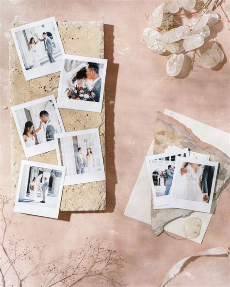 Several Polaroid Photos Are Laying On A Table Next To Some Dried