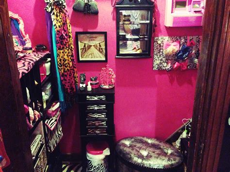 A Room With Pink Walls Zebra Print Rugs And Various Items On The Floor