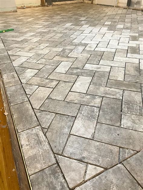 A Step By Step Guide To Starting Herringbone Tile In An Entryway