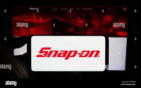 Person Holding Smartphone With Logo Of US Tools Company Snap On