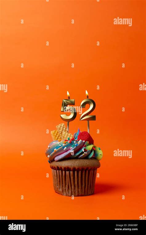 birthday cake with number 52 - cupcake on orange background with birthday candles Stock Photo ...