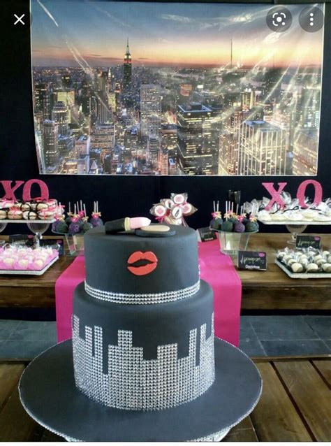 A Table Topped With Cakes And Cupcakes On Top Of A Wooden Table Next To