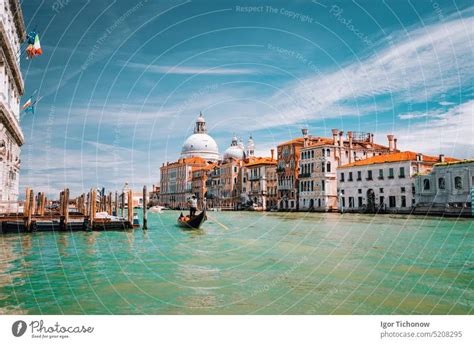 Grand Canal Tourist Boat With Basilica Santa Maria Della Salute Against Blue Sky And White