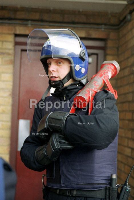 Police Officer In Riot Gear Holding The Enforcer A