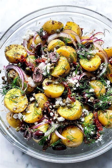 A Glass Bowl Filled With Potatoes And Onions