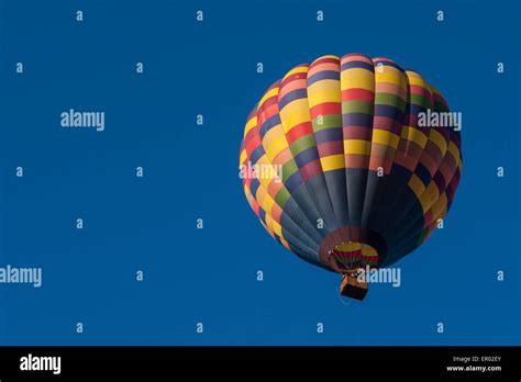 Hot Air Balloon Lifting Off From Field At Sunrise Stock Photo Alamy