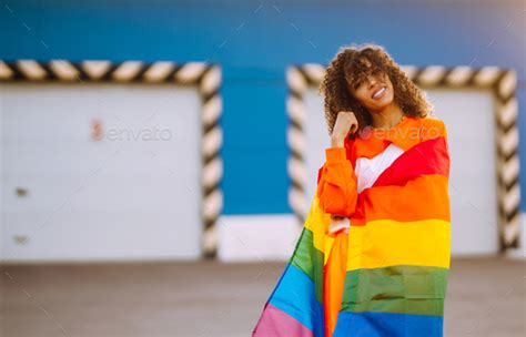 African American Lesbian Woman Holding Lgbt Rainbow Flag Concept