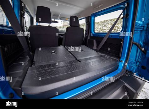 Side View Of Empty Open Car Trunk With Seats Folded Into Flat Flor Of