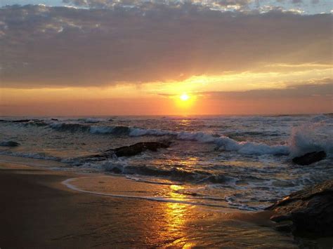 Stunning Ocean Sunset with Waves and Rocks