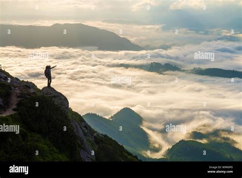 Wide Mountain Panorama Small Silhouette Of Tourist With Backpack On