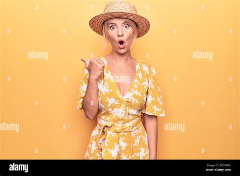 Beautiful Blonde Woman On Vacation Wearing Summer Hat And Dress Over