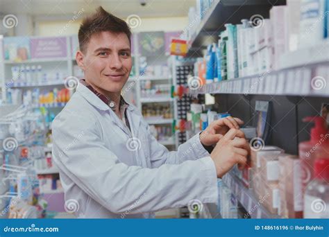 Handsome Male Pharmacist Working At His Drugstore Stock Photo Image