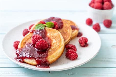 Premium Photo Pancake With Fresh Raspberries And Raspberry Sauce