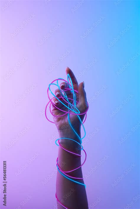 Female arm in blue and pink neon wires. Stock Photo | Adobe Stock