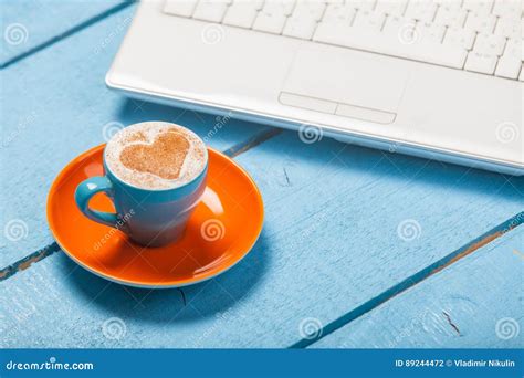 Photo Of Beautiful Blue Cup Of Coffee And Laptop On The Wonderful Blue