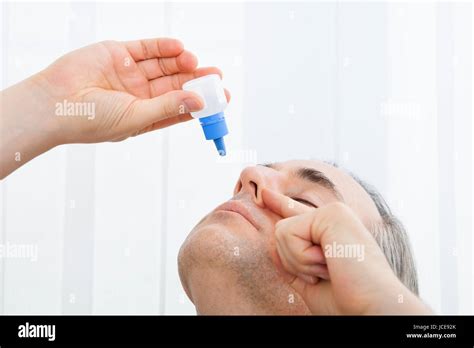 Close Up Of A Man Using Nasal Spray Indoors Stock Photo Alamy