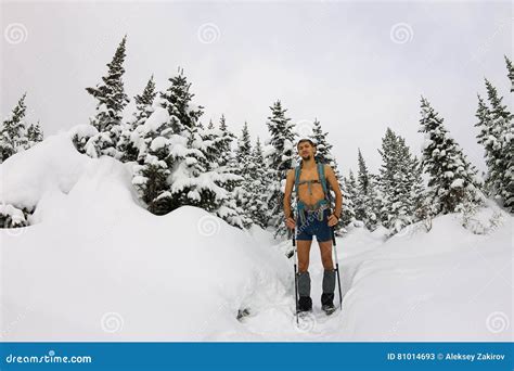 Male Tourist With A Backpack With A Naked Torso And Legs Is Among The