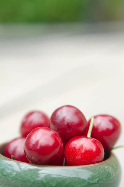 Premium Photo Cherries Close Up In Green Bowl Red Fruits On Wood With