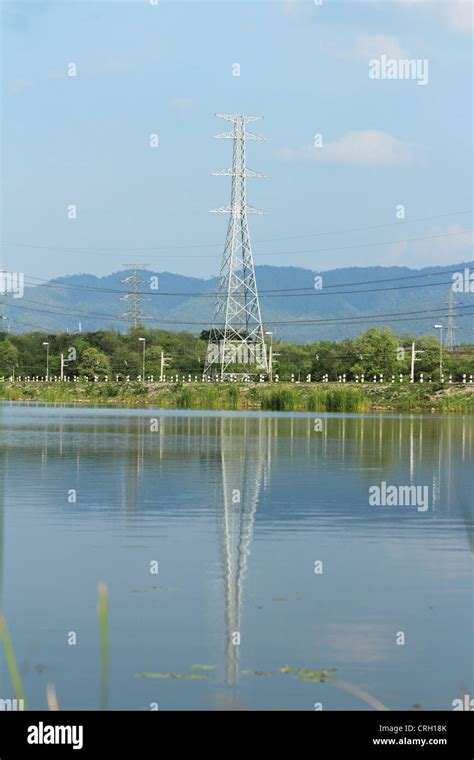 Electricity Pylon With Reflection In Water Stock Photo Alamy