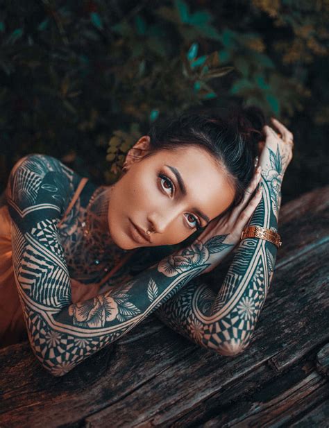 Download Vibrant Tattoo Girl Looking Into The Distance