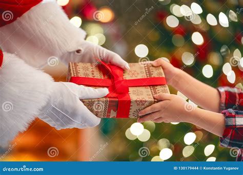 Santa Claus Giving T To Child Stock Photo Image Of Giving Lights