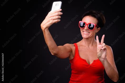 Mature Beautiful Woman With Short Hair Against Black Background Stock Photo Adobe Stock