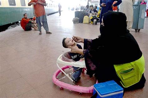 A lady health worker is administering Polio vaccine to a child during Polio free Pakistan ...