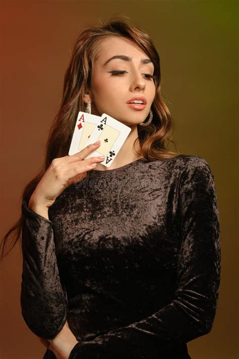 Brunette Woman In Black Velvet Dress And Jewelry Showing Two Aces