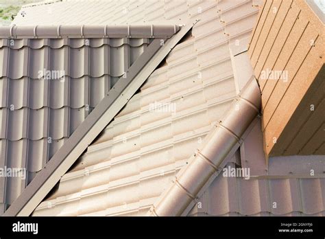 Detail Of House Roof Structure Covered With Brown Metal Tile Sheets