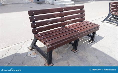 Wooden bench in the street stock image. Image of street - 148413069