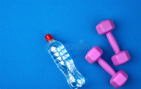 Transparent Plastic Bottle Of Water And A Pair Of Purple Plastic