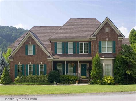 a large brick house with green shutters on the front and side windows ...