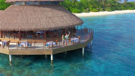 Aerial View on Young Couple in Water Restaurant on the Beach in ...