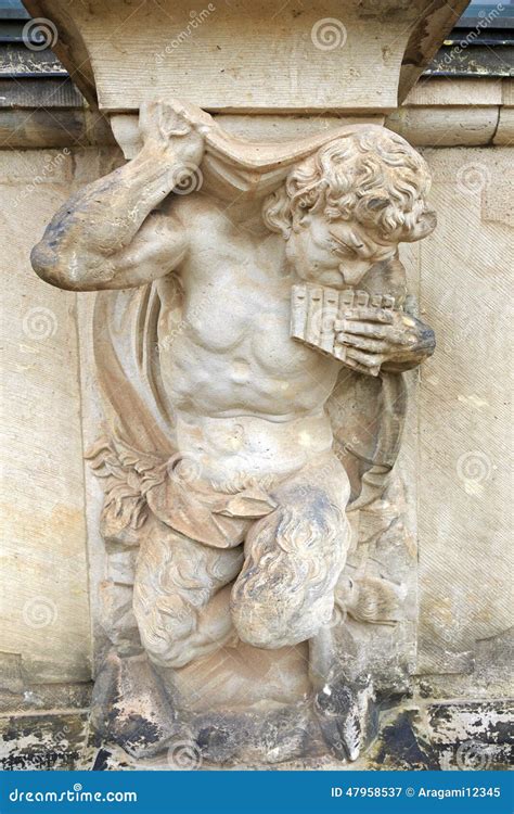 Closeup Half Naked Satyr Statue Playing Panpipe At Zwinger Palace Stock