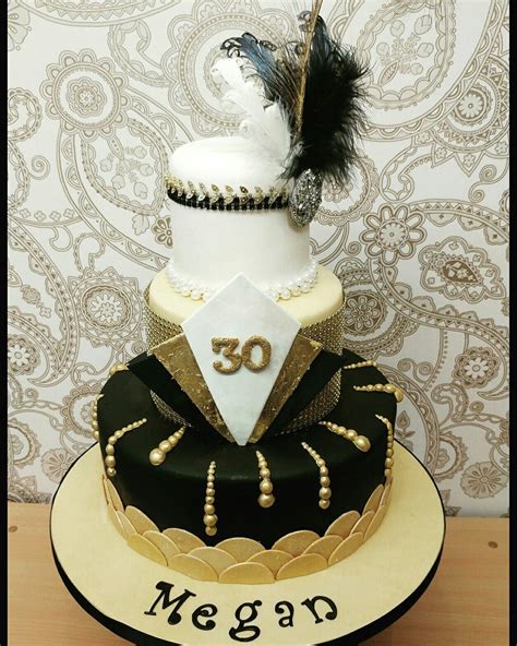 A Three Tiered Cake Decorated With Black And White Decorations