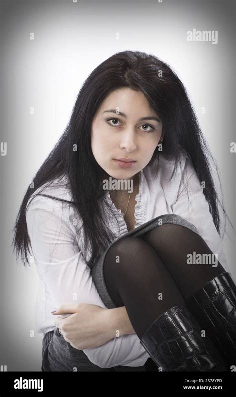 Brunette Girl Sitting On The Floor And Hugging Her Knees Moscow Russian Federation Stock Photo