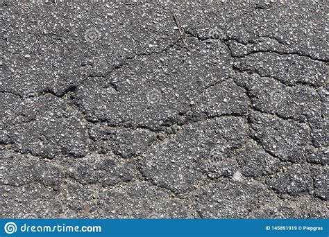 Close Up Surface Of Cracked Asphalt Roads In High Resolution Stock